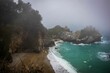 Foggy shot of McWay falls on the coastline of Big Sur in California
