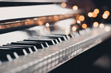 Piano keys over glow Christmas lights close up. Romantic lifestyle. Valentines Day.