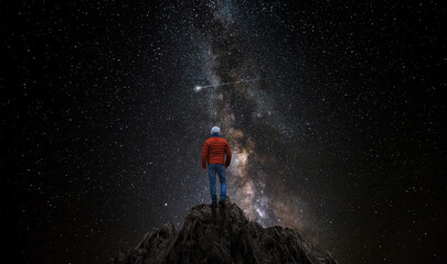 Wall Mural - man observes the universe from the top of a mountain