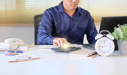 Poster - Finance and accounting concept, man accountant in office using calculator and laptop computer, businessman working at office