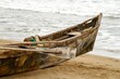 Old wooden boat parked on a seashore
