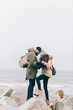 © Photocreo Bednarek - Couple trekking in winter by the sea.