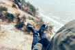 © Photocreo Bednarek - Man trekking in winter resting on cliff over the sea