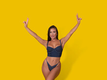 Woman In Underwear Gesturing V Sign