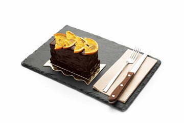 Poster - Slice of cake with orange on wooden board isolated in white background