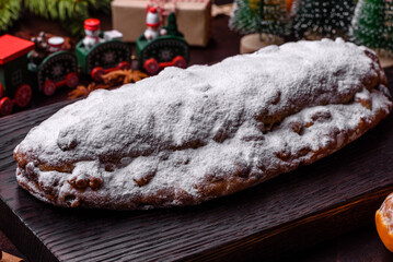 Wall Mural - Christmas pie stollen with marzipan, berries and nuts on a dark concrete background