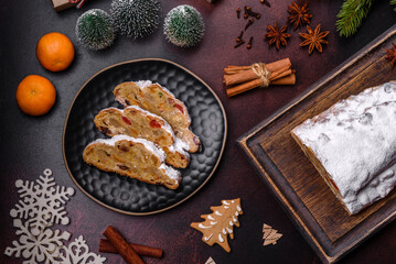 Wall Mural - Christmas pie stollen with marzipan, berries and nuts on a dark concrete background