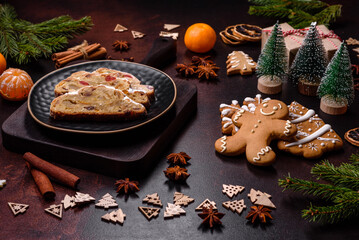 Wall Mural - Christmas pie stollen with marzipan, berries and nuts on a dark concrete background