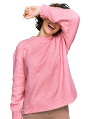 Poster - Young hispanic woman wearing casual clothes covering eyes with arm smiling cheerful and funny. blind concept.