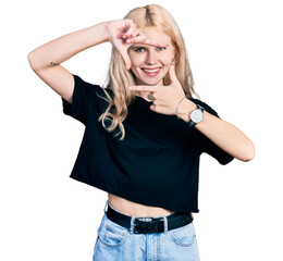 Poster - Young caucasian woman wearing casual clothes smiling making frame with hands and fingers with happy face. creativity and photography concept.