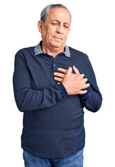 Wall Mural - Senior handsome man wearing casual polo smiling with hands on chest with closed eyes and grateful gesture on face. health concept.