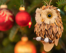 Rustic Wooden Owl Ornament Hanging In A Christmas Tree.