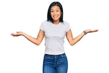 Wall Mural - Beautiful hispanic woman wearing casual white tshirt smiling showing both hands open palms, presenting and advertising comparison and balance