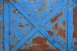 rusty blue metal plate with cross detail