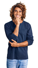 Wall Mural - Young hispanic man wearing casual clothes looking confident at the camera with smile with crossed arms and hand raised on chin. thinking positive.