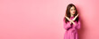 © Mix and Match Studio - Displeased angry woman blocking offer, showing cross stop gesture, saying no and shaking head in negative reply, standing over pink background