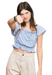 Canvas Print - Young beautiful caucasian girl wearing casual clothes looking unhappy and angry showing rejection and negative with thumbs down gesture. bad expression.