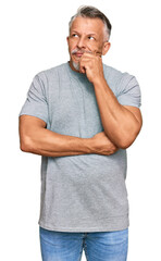 Poster - Middle age grey-haired man wearing casual clothes serious face thinking about question with hand on chin, thoughtful about confusing idea