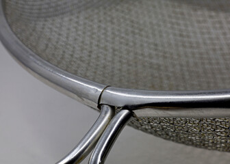 close-up metal strainer detail. Domestic kitchen utensils