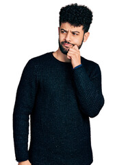 Sticker - Young arab man with beard wearing casual winter sweater thinking concentrated about doubt with finger on chin and looking up wondering