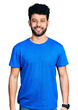 © Krakenimages.com - Young arab man with beard wearing casual blue t shirt with a happy and cool smile on face. lucky person.