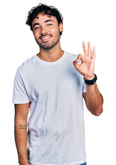 Wall Mural - Hispanic young man with beard wearing casual white t shirt showing and pointing up with fingers number three while smiling confident and happy.