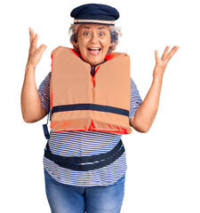 Poster - Senior woman with gray hair wearing nautical lifejacket celebrating victory with happy smile and winner expression with raised hands