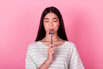 Wall Mural - Portrait of lovely pretty girl closed eyes arm hold lick spoon imagine isolated on pink color background