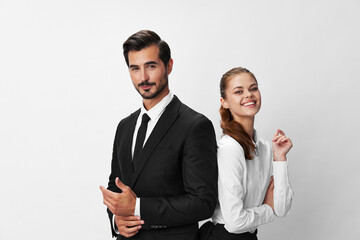 Wall Mural - Man and woman smile with teeth business in business attire looking into camera on white isolated background. Stylish business concept paired between employees startup copy place