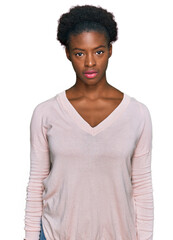 Poster - Young african american girl wearing casual clothes relaxed with serious expression on face. simple and natural looking at the camera.