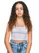 © Krakenimages.com - Teenager hispanic girl wearing casual clothes relaxed with serious expression on face. simple and natural looking at the camera.
