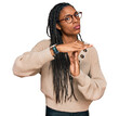 © Krakenimages.com - African american woman wearing casual clothes doing time out gesture with hands, frustrated and serious face