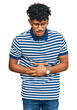 © Krakenimages.com - Young arab man wearing casual clothes and glasses with hand on stomach because indigestion, painful illness feeling unwell. ache concept.