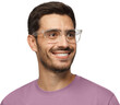 © Damir Khabirov - Close-up portrait of smiling handsome male in purple t-shirt and transparent eyeglasses looking right