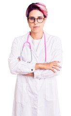 Sticker - Young beautiful woman with pink hair wearing doctor uniform skeptic and nervous, disapproving expression on face with crossed arms. negative person.