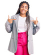 © Krakenimages.com - Young african american woman with braids wearing business clothes looking confident with smile on face, pointing oneself with fingers proud and happy.