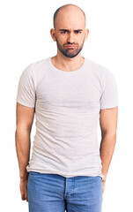 Poster - Young handsome man wearing casual t shirt depressed and worry for distress, crying angry and afraid. sad expression.