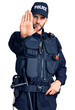 © Krakenimages.com - Young handsome man with beard wearing police uniform doing stop sing with palm of the hand. warning expression with negative and serious gesture on the face.