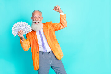 Canvas Print - Photo of delighted successful grandfather hold cash banknotes bills raise fist celebrate isolated on turquoise color background