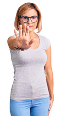 Sticker - Young blonde woman wearing casual clothes doing stop sing with palm of the hand. warning expression with negative and serious gesture on the face.