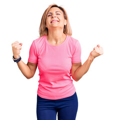 Poster - Young blonde woman wearing sportswear very happy and excited doing winner gesture with arms raised, smiling and screaming for success. celebration concept.