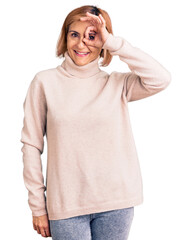 Sticker - Young blonde woman wearing casual clothes smiling happy doing ok sign with hand on eye looking through fingers