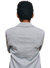 Canvas Print - Young african american woman wearing business clothes standing backwards looking away with crossed arms