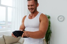 Man Sports Arm Pain Muscle And Ligament Sprain From Working Out At Home, Pumped Up Man Fitness Trainer Works Out At Home, The Concept Of Health And Body Beauty
