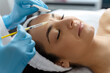 Cosmetologist does prp therapy on the face of a beautiful woman in a beauty salon