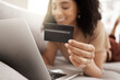 © Rene L/peopleimages.com - Hand, credit card and online shopping with a black woman customer using her laptop in the living room. Finance, computer and accounting with a female consumer spending money through ecommerce