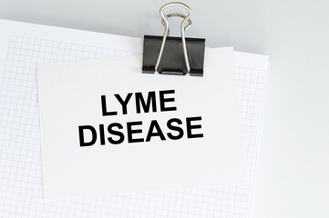 Wall Mural - Lyme disease inscription on a card clip to a sheet of notepad on a light background