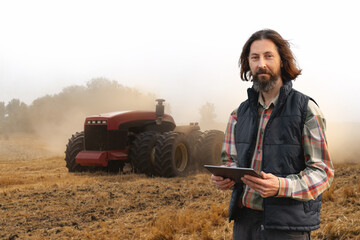 Autocollant - Farmer with digital tablet controls an autonomous tractor on a smart farm	