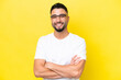 Young Arab handsome man isolated on yellow background With glasses with happy expression