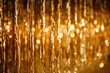 Leinwandbild Motiv Shiny golden foil drop fringe tinsel curtain rain garlands decoration for glamour holidays party